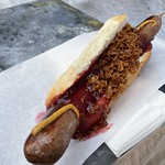 Reindeer sausage with lingonberry, mustard, grilled onions at Tre Kronoren in Bergen, Norway